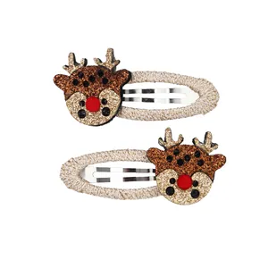 Detail of Christmas reindeer hair clips with glitter fabric and woven wrapped BB clips