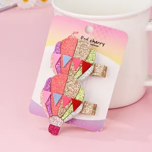 Detail of glitter hot air balloon hair clips set on display card with a mug background