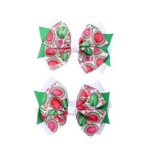 Close-up of double-layered ribbon hair clips with vibrant watermelon print for girls