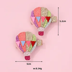 Detail of hot air balloon hair clips with colorful glitter finish and size measurements