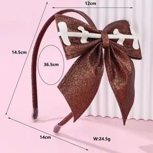 Sparkly brown sequin football bow headband with white stitching on pink background