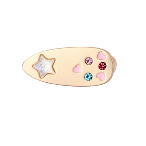 Detail of gold alloy teardrop hair clip with pink hearts and sparkling colorful rhinestones
