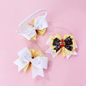 Detail of school-themed bow headband and hair clips with apple and book icons