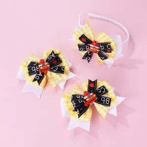 Detail of school-themed hair set with yellow plaid bows and miniature book decorations