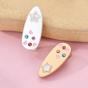 Detail of sweet heart and star patterned hair clips with colorful rhinestones decor