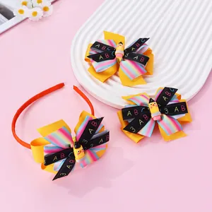 Detail of school-themed hair accessories with rainbow bows and pencil charms for kids