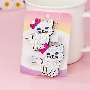 Close-up of white sequined cat hair clips with pink glitter bows for girls