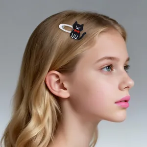Sparkling black cat hair clip with red bow on a young model with blonde hair