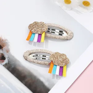 Detail of glittery cloud hair clips with colorful rainbow ribbons for children