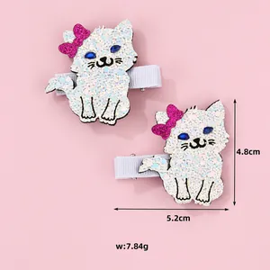 Close-up of glitter cat hair clips with pink bows and dimensions 5.2cm by 4.8cm