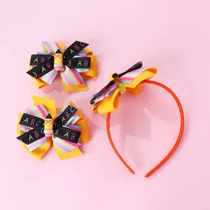 Detail of school-themed bow headband and hair clips with pencil resin and ABC ribbon
