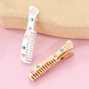 Detail of comb-shaped hair clips with cherry blossom patterns and colorful rhinestones