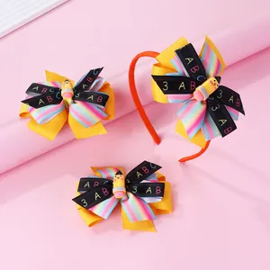 Detail of school themed bow headband and hair clips with pencil decor and ABC ribbon