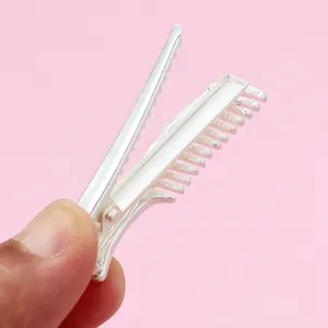 Detailed view of silver alloy hair clip with a creative comb-shaped design and metal teeth