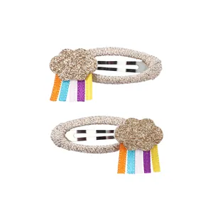 Detail of glitter cloud hair clips with colorful rainbow tassels and woven BB clips