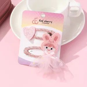 Close-up of pink rabbit embroidery and glitter heart hair clips for girls