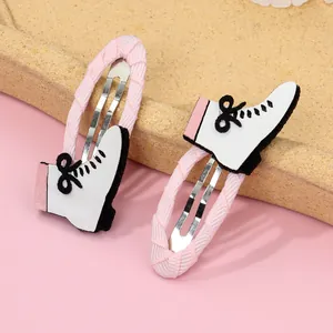 Detalle de pinzas para el pelo de patines rosas con lentejuelas y cinta de tela acanalada