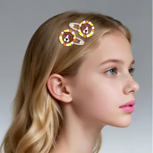 Detailed view of handmade cartoon lion hair clips worn on a child's hair for styling