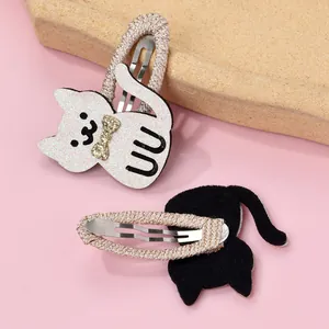 Detailed view of cat hair clips featuring glitter surface and woven edge metal base