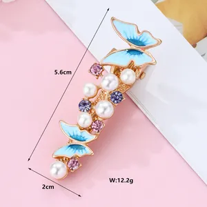Detail of blue butterfly hair clip with pearls and rhinestones showing 5.6cm length