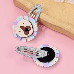 Front and back detail of cartoon animal hair clips with colorful pleated fabric edges