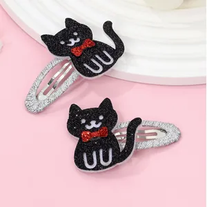 Pair of cartoon black cat hair clips with red sequin bows and glitter finish