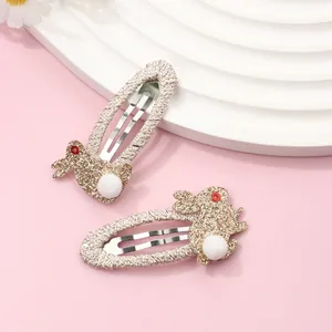 Detail of glitter rabbit hair clips with plush ball tails and woven metal BB clips