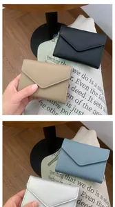 Litchi pattern leather envelope wallets with metal chains in four colors on a canvas background