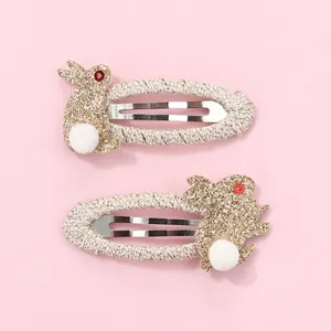 Close-up of glitter rabbit hair clips with woven pink edges and sparkling details