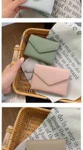 Detailed view of mini envelope wallets with lychee texture and delicate silver chains