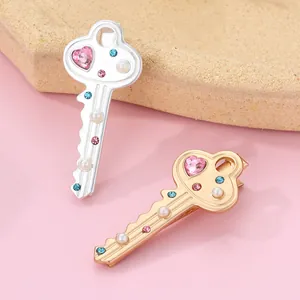 Detailed macro view of heart crystal and pearls on gold and silver key hair clips