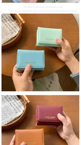 Detail of cross-grain leather wallets in multiple colors with metal zipper closure