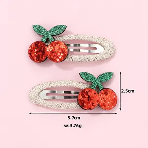 Detail view of glitter cherry hair clips with dimensions 5.7cm and weight 3.76g
