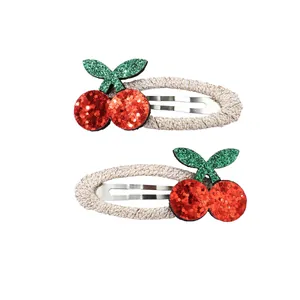 Detail of red glitter cherry hair clips with woven anti-slip fabric wrap for children