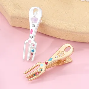 Detail of creative fork-shaped alloy hair clips with floral and rhinestone decorations