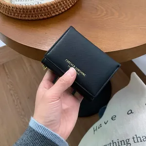 Short black cross-pattern leather wallet with gold zipper and Forever Sunshine text