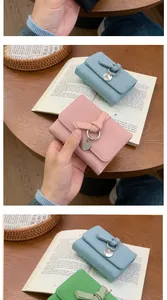 Vertical view of trifold wallets in pink blue and green with lychee grain leather