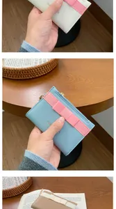 Detail view of small card purses with zipper and ribbon bow in multiple pastel colors