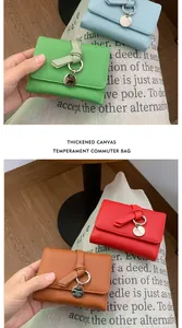 Detail of lychee textured leather wallets with knotted strap and round metal charms