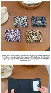 Detail view of the interior slots and leopard print textures of this women's trifold wallet