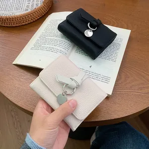 Minimalist tri-fold short wallet with lychee texture and metal pendant in black and beige