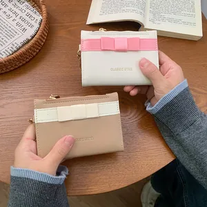 Chic women's leather coin purse with bow accent and zip closure, handheld daily wallet