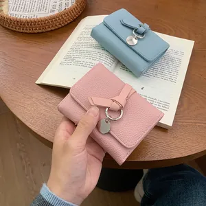Three-fold leather wallets with bow detail in pink and blue for women