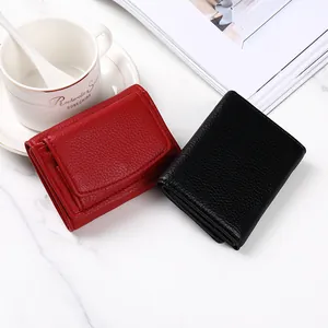 Portafogli trifold in pelle con motivo litchi in nero e rosso sul marmo