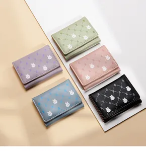 Flat lay of colorful minimalist short wallets featuring cute cartoon rabbit prints
