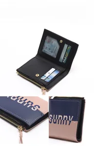 Detail view of bi-fold wallet featuring navy and pink leather with sunny embroidery