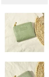 Detail of light green short wallet with vintage wrinkled texture and golden zipper closure