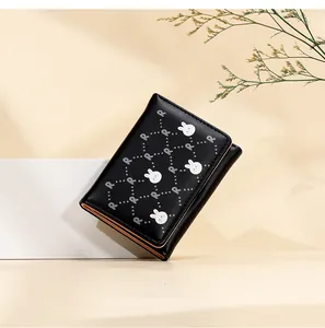 Close-up of black trifold wallet featuring white bunny and letter R quilted pattern
