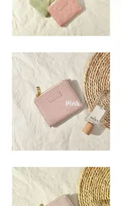 Close-up of lotus pink and light green PU leather wallets with gold zippers and MO MO DOG label