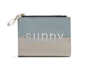 Detail view of Morandi-colored PU leather wallet with sunny embroidery and silver zipper